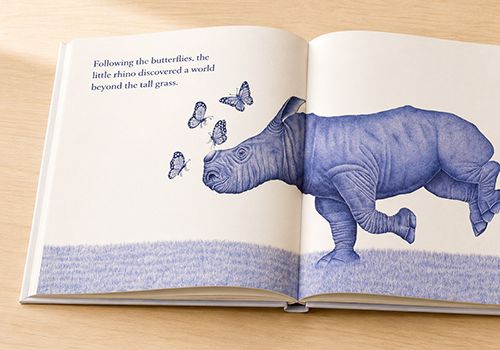 A picture-book spread with a rhino and butterflies