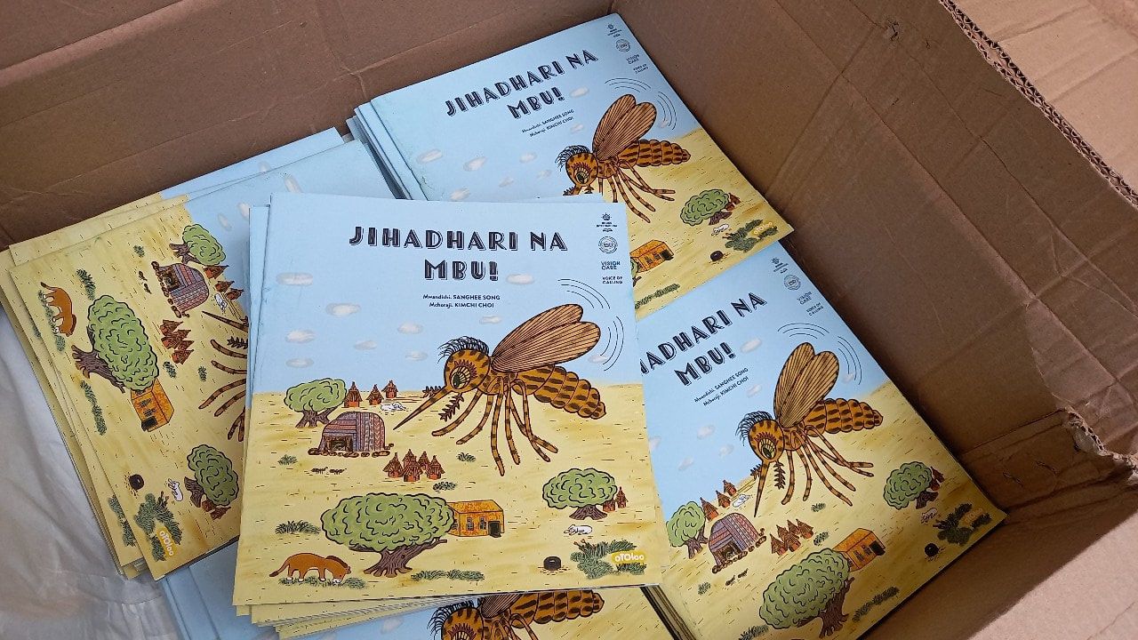 A box of freshly printed copies of Jihadhari na Mbu!