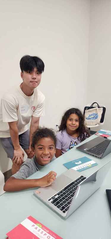 Season 3: a volunteer teaching at a laptop