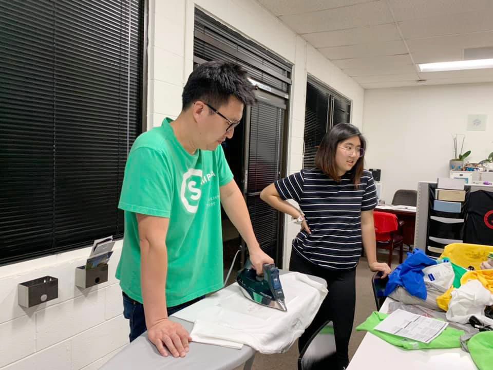 Two members setting up equipment