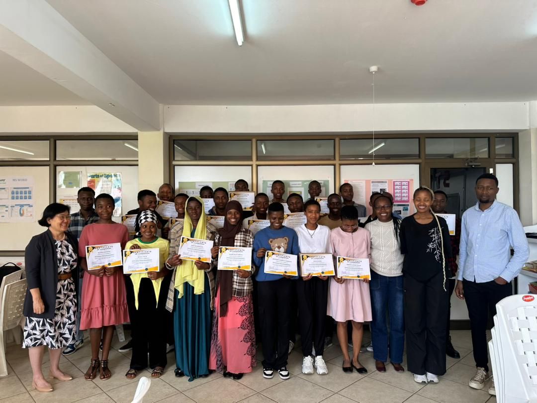 Students at E3Empower in Tanzania holding their course certificates